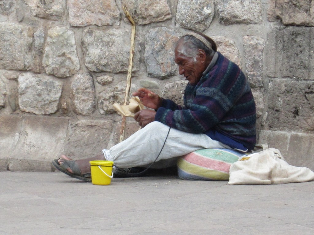 A man begs on the streets of Cusco, Peru
